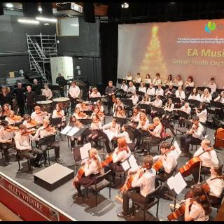 Young musicians performing in youth orchestra concert