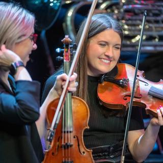 Staff orchestra on stage at Millennium Forum