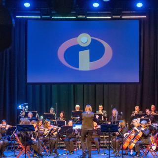 Staff orchestra on stage at Millennium Forum