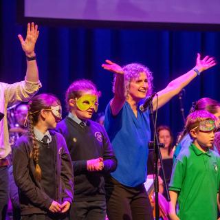 Musical Pathways staff and primary school participants on stage at Millennium Forum