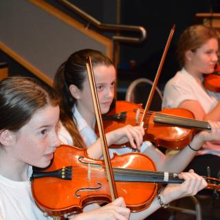 Young musicians performing in concert