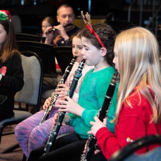 Children playing clarinets at a Christmas concert
