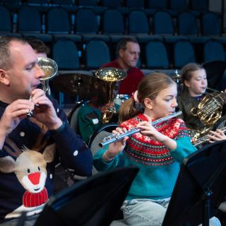 Flute and piccolo players perform at a Christmas concert