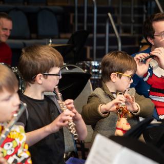 Flute and piccolo players perform at a Christmas concert