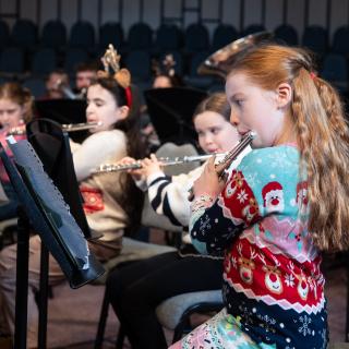 Children playing flutes performing at a Christmas concert