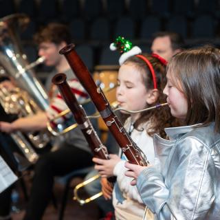 Children playing bassoons performing at a Christmas concert