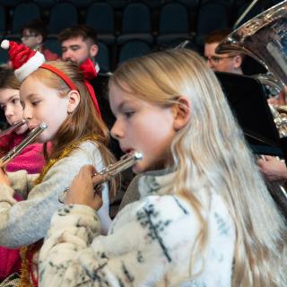 Children playing flutes performing at a Christmas concert