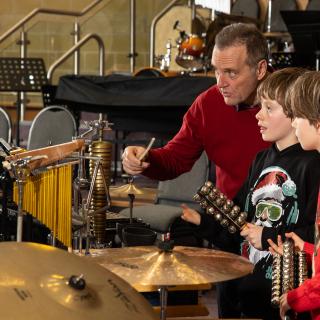 Children playing percussion instruments performing at a Christmas concert