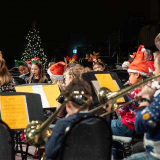 Children playing musical instruments performing at a Christmas concert