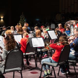 Children playing musical instruments performing at a Christmas concert