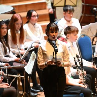 A young person introducing a concert in the Ulster Hall.