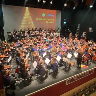 Young musicians from Strabane and Omagh orchestra performing in concert