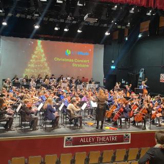 Young musicians from Strabane and Omagh orchestra performing in concert