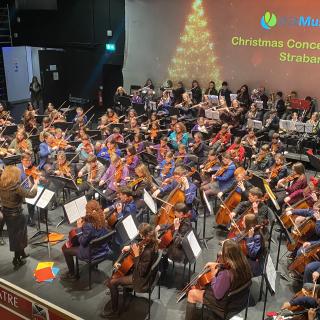 Young musicians from Strabane and Omagh orchestra performing in concert