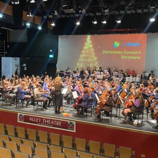 Young musicians from Strabane and Omagh orchestra performing in concert