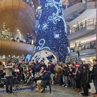 Children and young people singing and playing brass instruments at Christmas