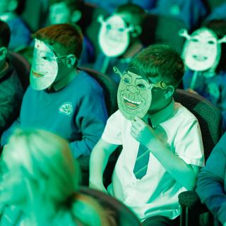 Photo of audience wearing Shrek masks at Springfest