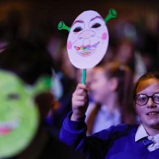 Photo of audience wearing Shrek masks at Springfest