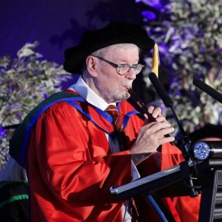 Sir James Galway performong at a ceremony where he received an honorary doctorate from Ulster University
