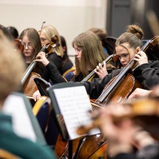 Pupils performing in an orchestra