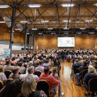 Youth orchestra performing in full hall
