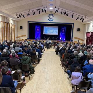 Youth orchestra performing in full hall