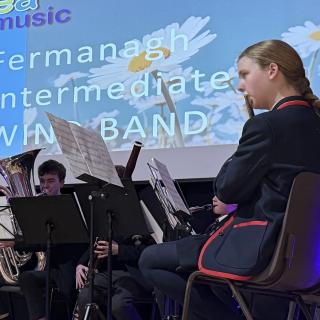 Flute and tuba players in concert