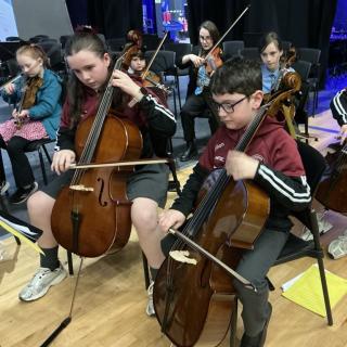 Cello section of youth orchestra