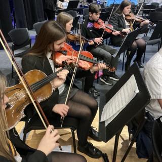 Pupils performing in an orchestra