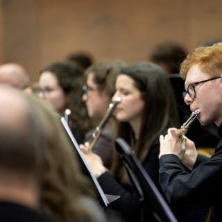 Young woodwind musicians performing in a concert
