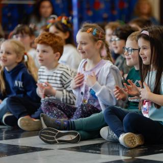 Young musicians performing vocal activities in a rehearsal