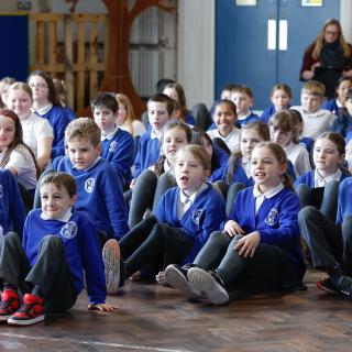 Young musicians performing vocal activities in a Benedetti rehearsal