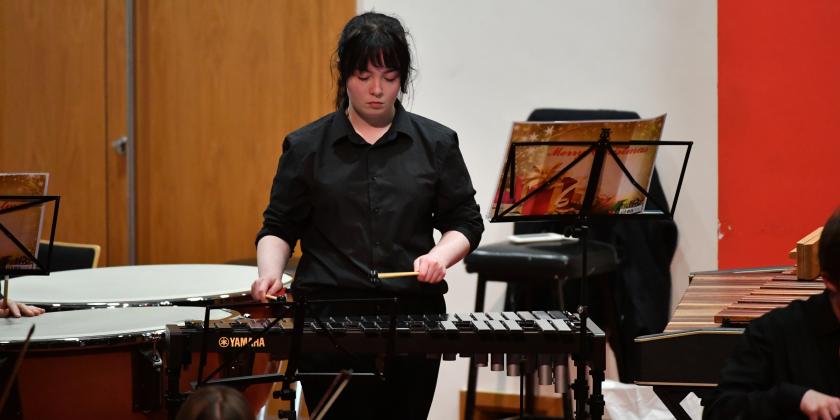 Youth orchestra member playing glockenspiel in concert
