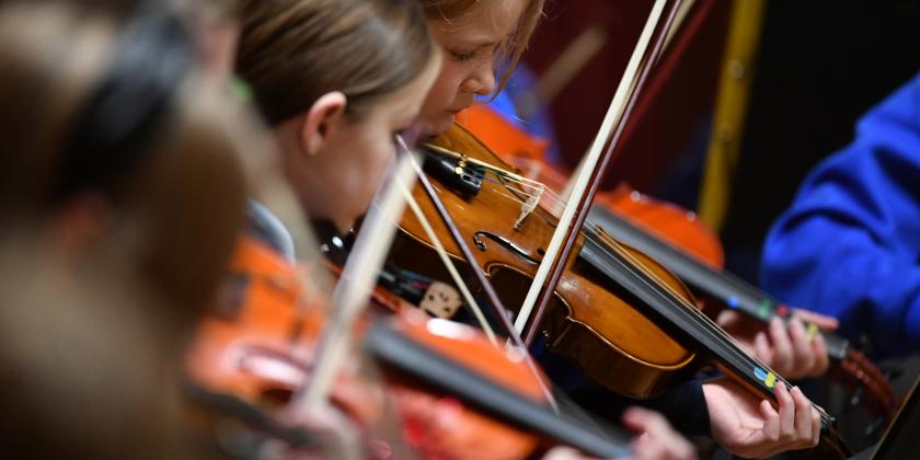 Primary school violinists performing in concert