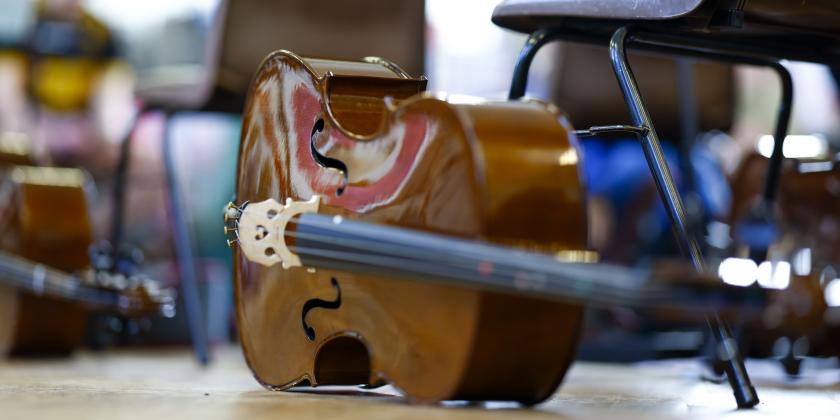 cello on floor in orchestra rehearsal